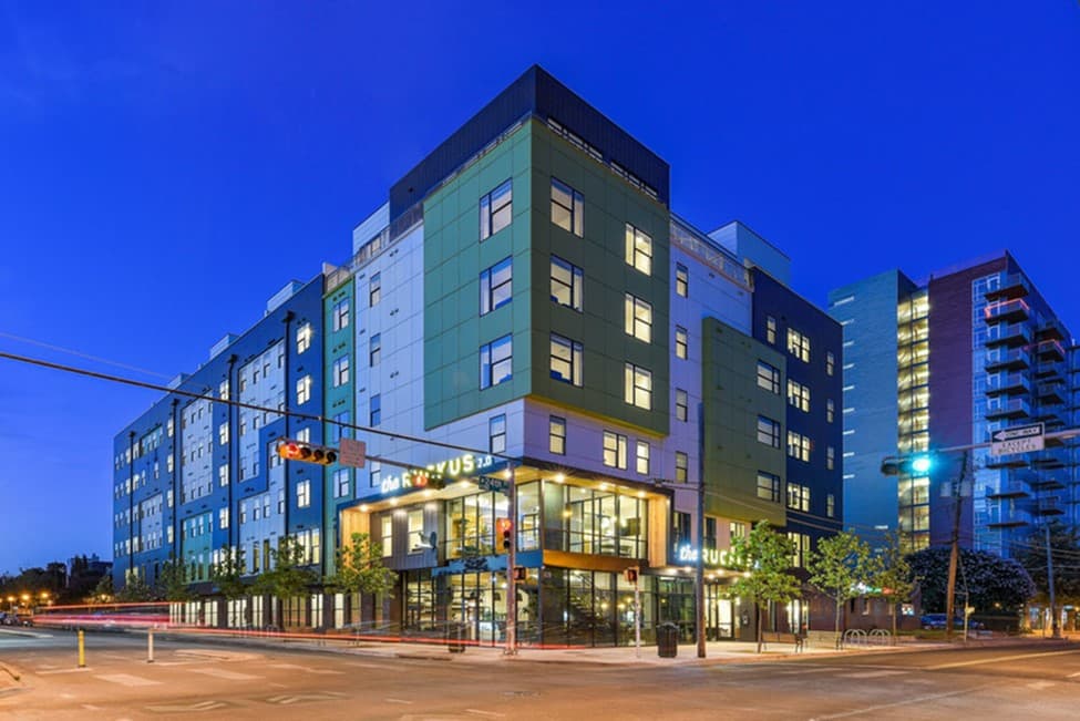 The outside facade of a student housing asset at night.
