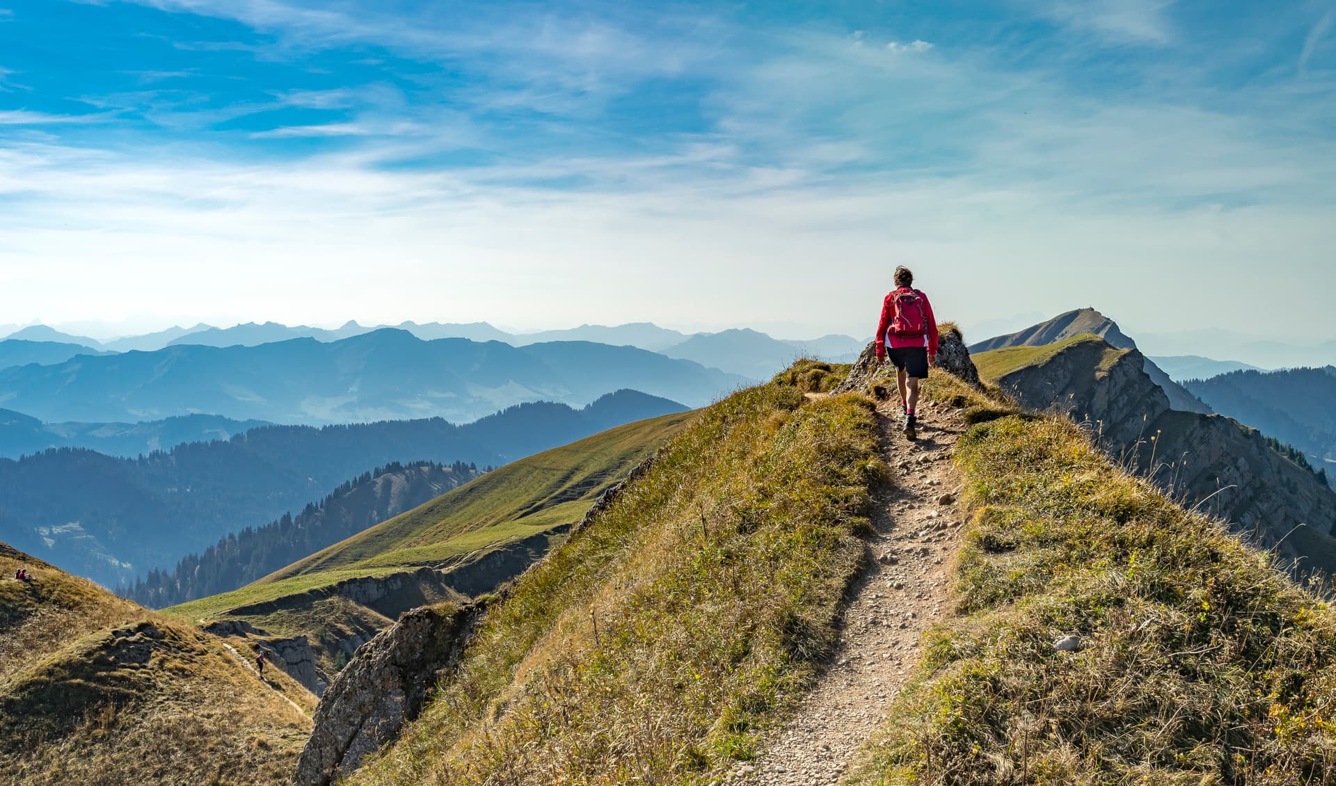 Woman hiking over the ridge of the Nagelfluh mountain range, Bavaria