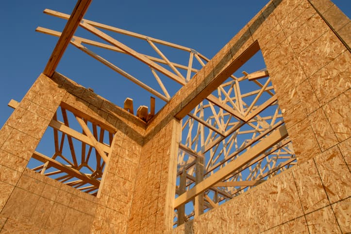 Framing of a new home with a blue sky in background.