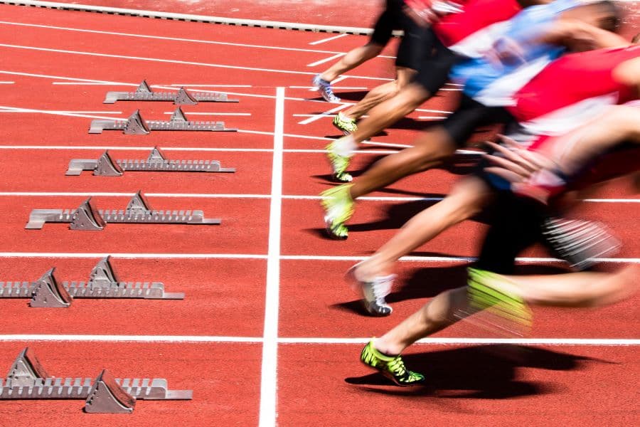 Photo of athletes starting to sprint.