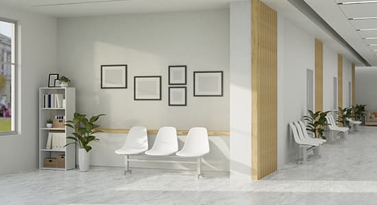 Empty white chairs in a sand-colored medical office.