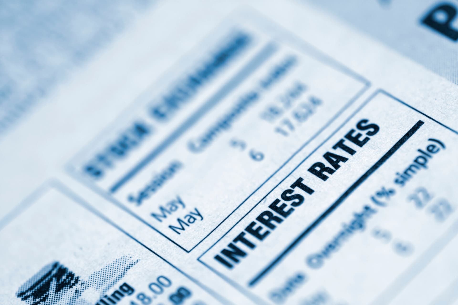 Closeup of "interest rates" text in a newspaper