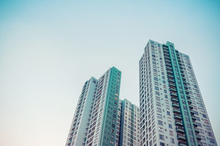 Modern Luxury Condo Building on a sunny day with a blue sky.