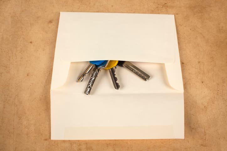A set of keys being sent back in an envelope.