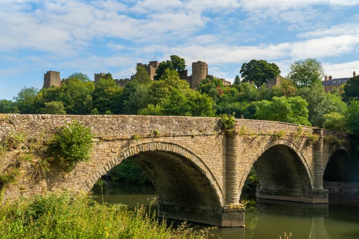 Dinham bridge over the River Teme with Ludlow castle behind in the town of Ludlow, Shropshire UK in Landscape orientation
