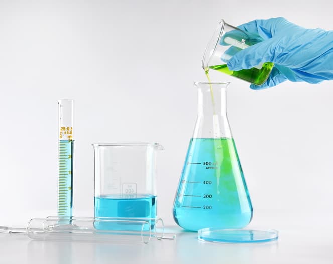 Chemist formulating solution substances, Scientist with equipment and science experiments, Laboratory glassware containing chemical liquid.