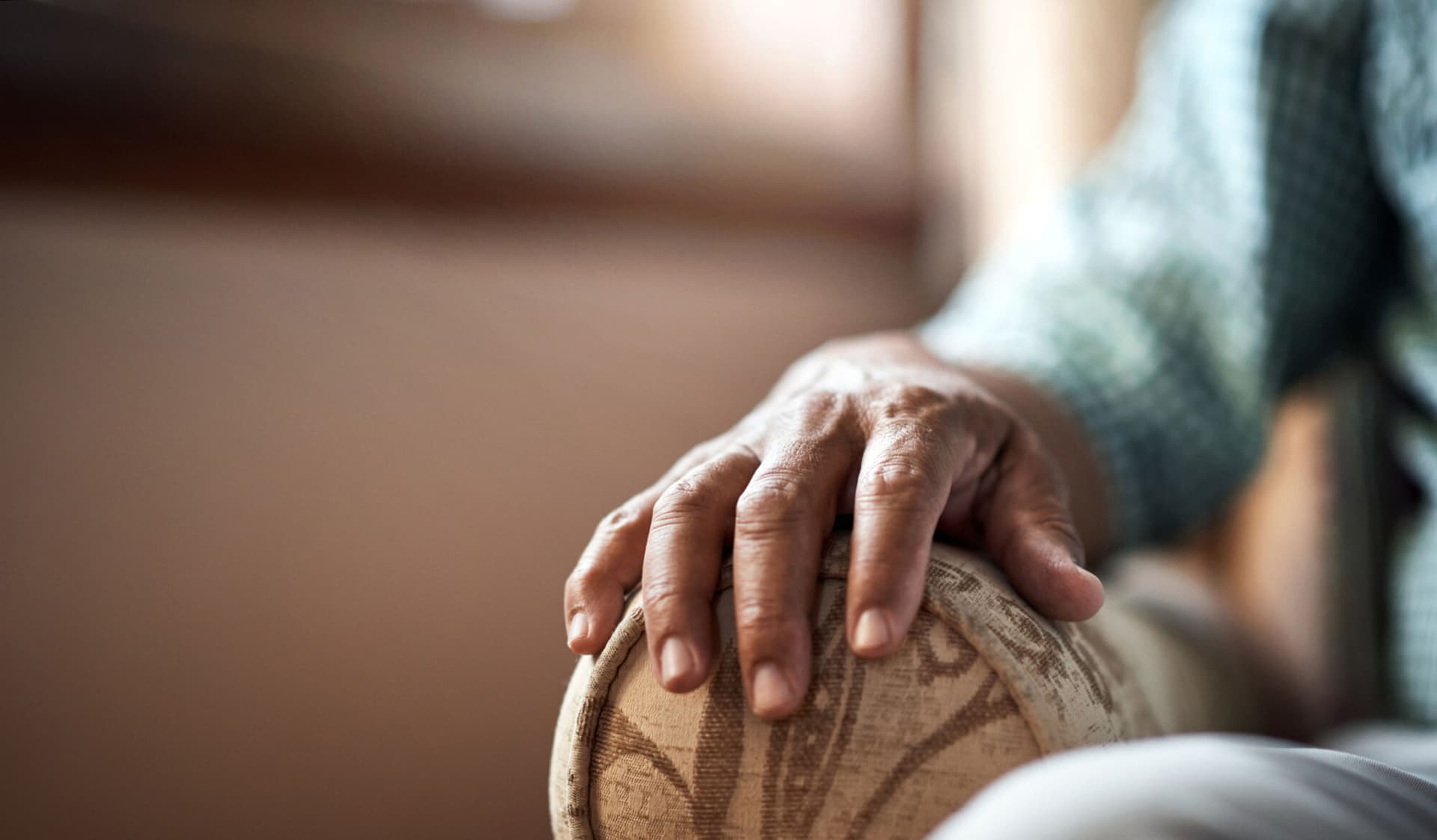 Elderly person sitting in armchair