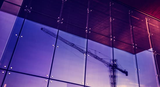 High tower crane reflected in window