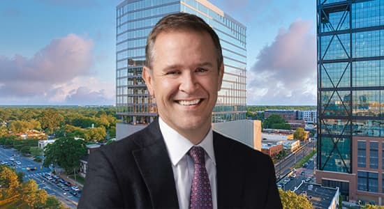 Peter Gordon, head and chief investment officer, US commercial real estate debt, at AllianceBernstein in front of an image of 110 East Boulevard in Charlotte, North Carolina.