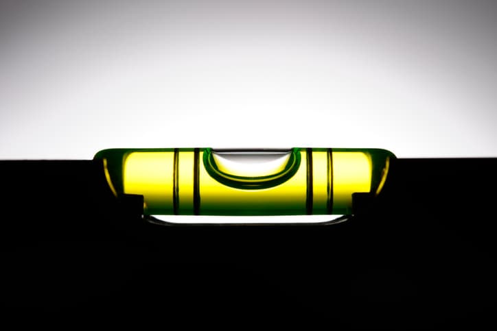 Silhouette of level against white background with copy space.