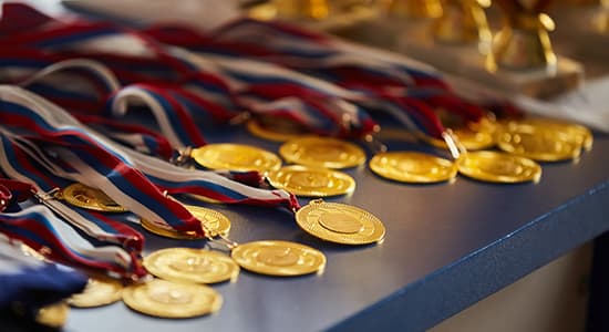 Numerous sports medals displayed on a table