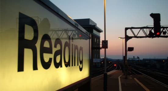 A sign that reads "Reading" on the platform at Reading Train Station