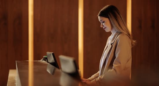 Woman working at a hotel reception desk