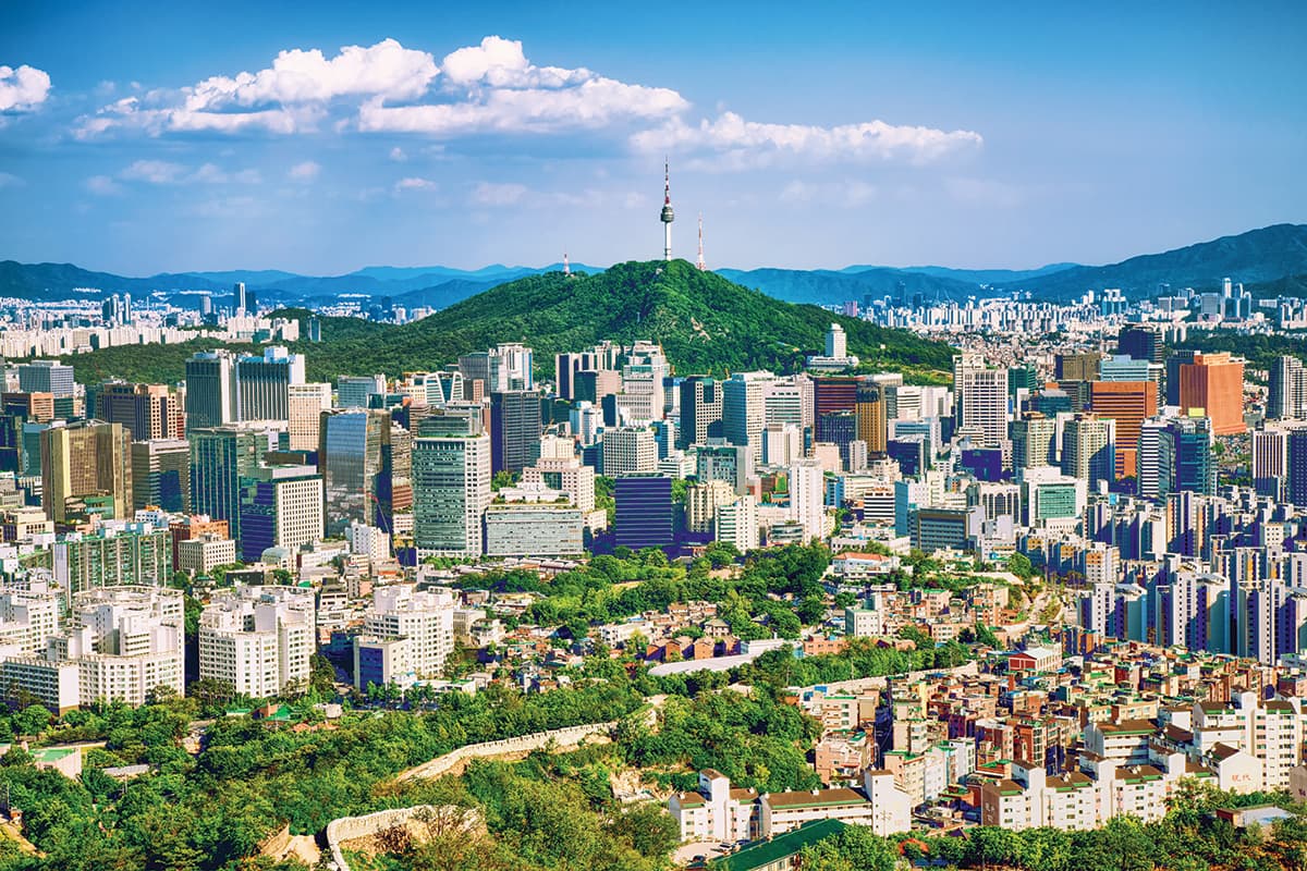 Seoul downtown cityscape with fortress and Namsan Seoul Tower on sunset Seoul, South Korea.