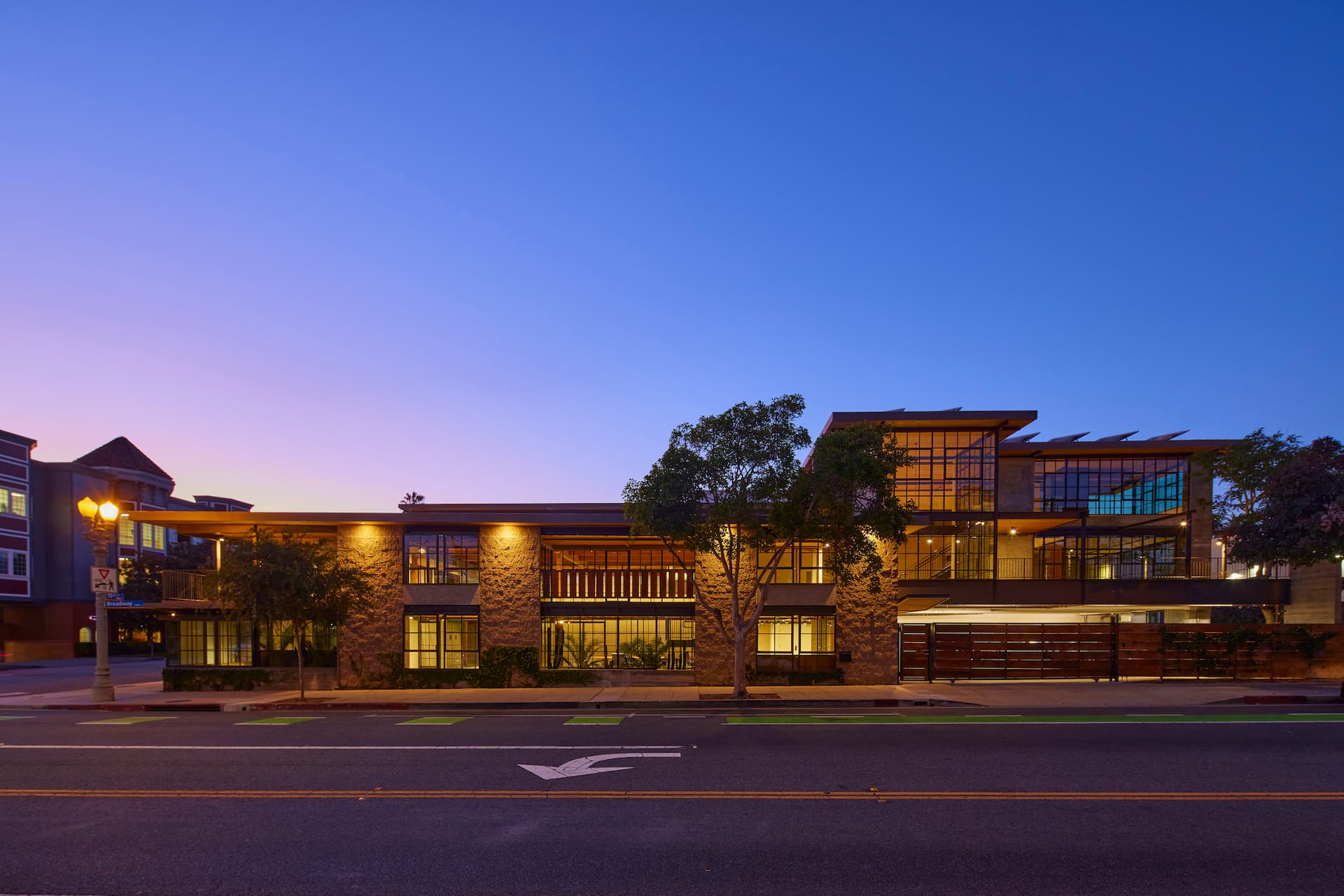 Creative office building with road in front and violet sky