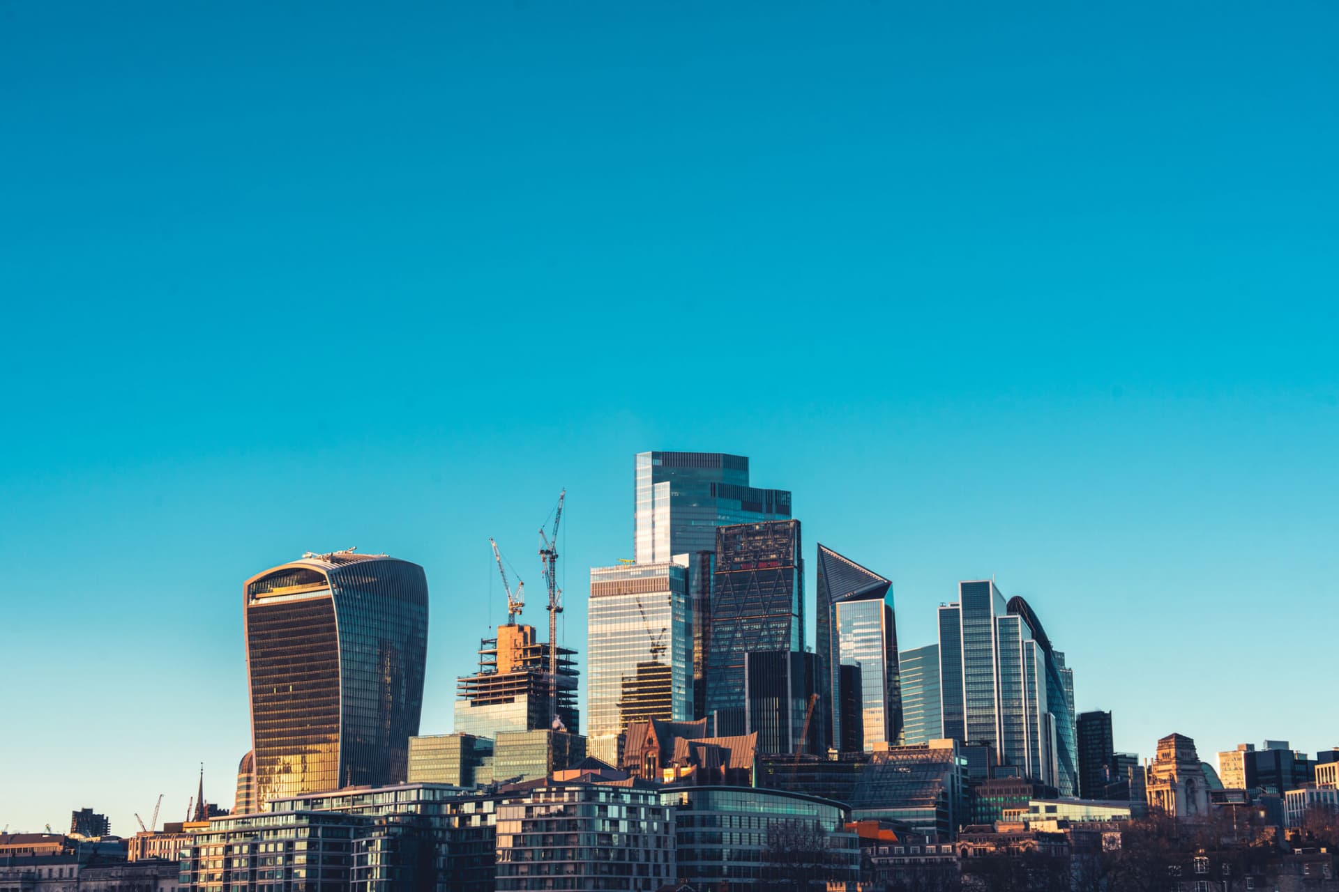 Skyline of City of London with corporate office buildings of at sunset