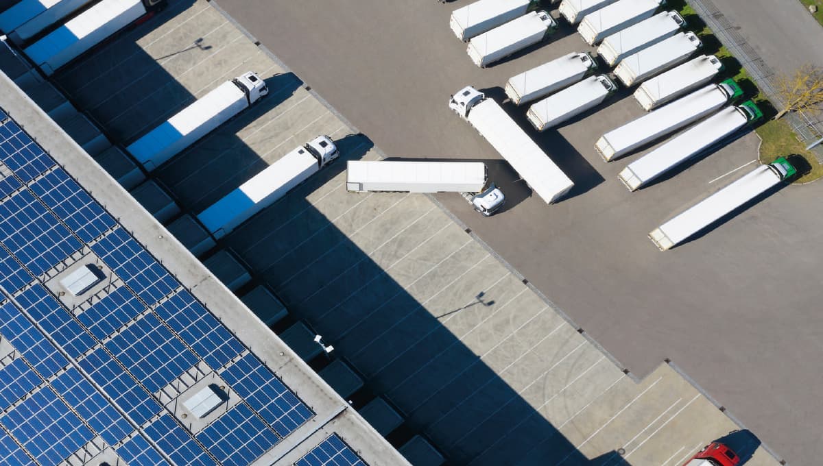 Image of trailers in and leaving a warehouse.