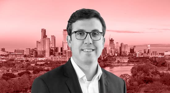 A headshot of Andy Power in front of a photo of Austin, Texas